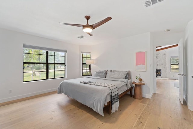 14406 Tucumcari Trl, Austin, TX 78734 - bedroom featuring light wood-style floors, multiple windows, and baseboards