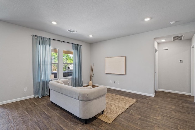 13921 Allan Shivers St, Manor, TX 78653 - living room with dark wood finished floors, baseboards, recessed lighting, and a textured ceiling
