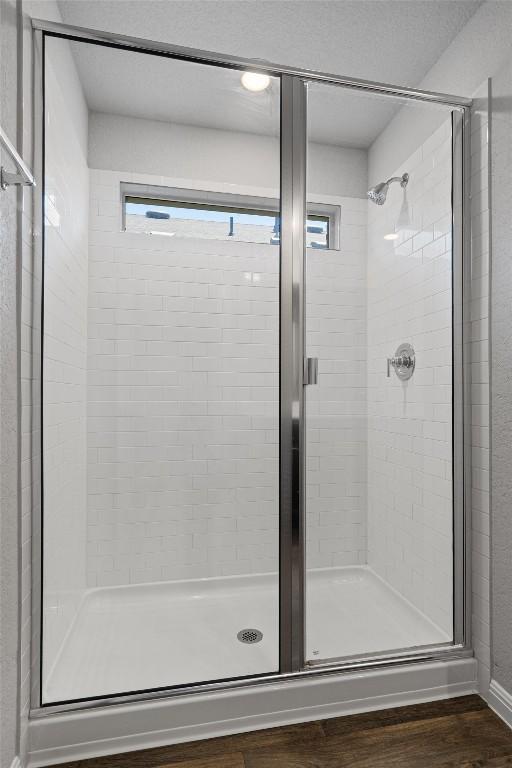13921 Allan Shivers St, Manor, TX 78653 - full bathroom featuring a stall shower and wood finished floors