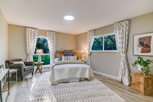 bedroom with wood finished floors and baseboards