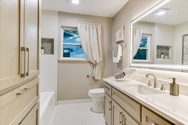 bathroom featuring toilet, vanity, baseboards, and tile patterned flooring