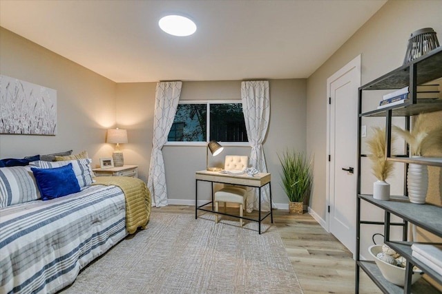bedroom with wood finished floors and baseboards