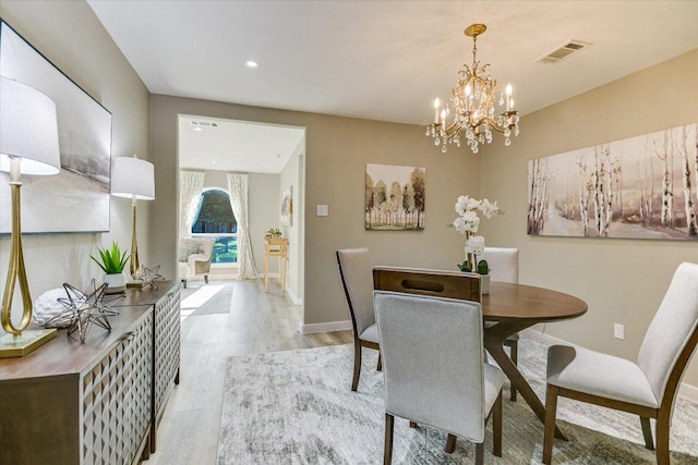dining space featuring light wood-type flooring, baseboards, a chandelier, and recessed lighting