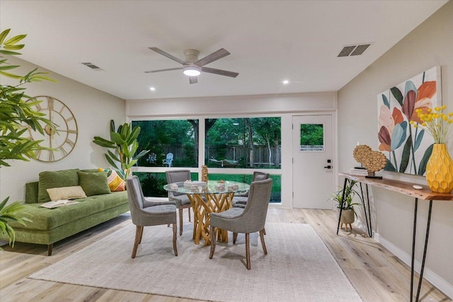 dining room with light wood-style flooring, a ceiling fan, recessed lighting, and baseboards
