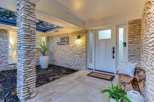 view of exterior entry featuring a porch