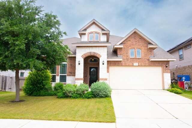 3119 Brand Iron Dr, San Marcos, TX 78666 - french country style house with brick siding, driveway, and a shingled roof