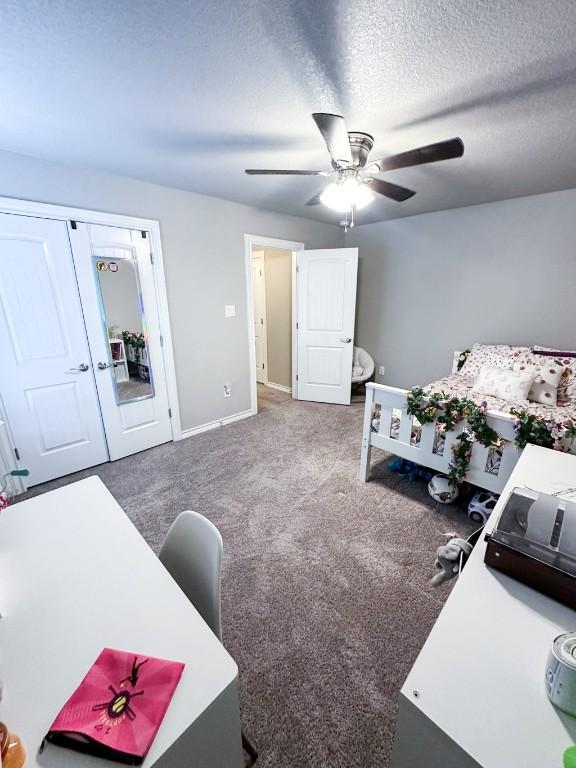3119 Brand Iron Dr, San Marcos, TX 78666 - carpeted bedroom with baseboards, an office area, a ceiling fan, and a textured ceiling