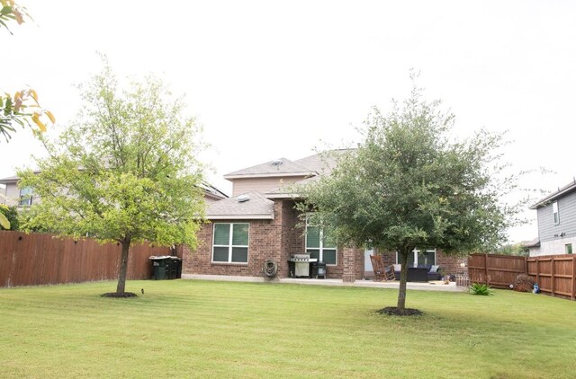 3119 Brand Iron Dr, San Marcos, TX 78666 - back of property featuring brick siding, a patio, and a shingled roof