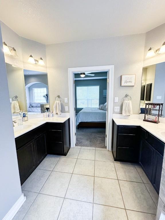 3119 Brand Iron Dr, San Marcos, TX 78666 - full bath featuring ensuite bath, tile patterned flooring, plenty of natural light, and two vanities