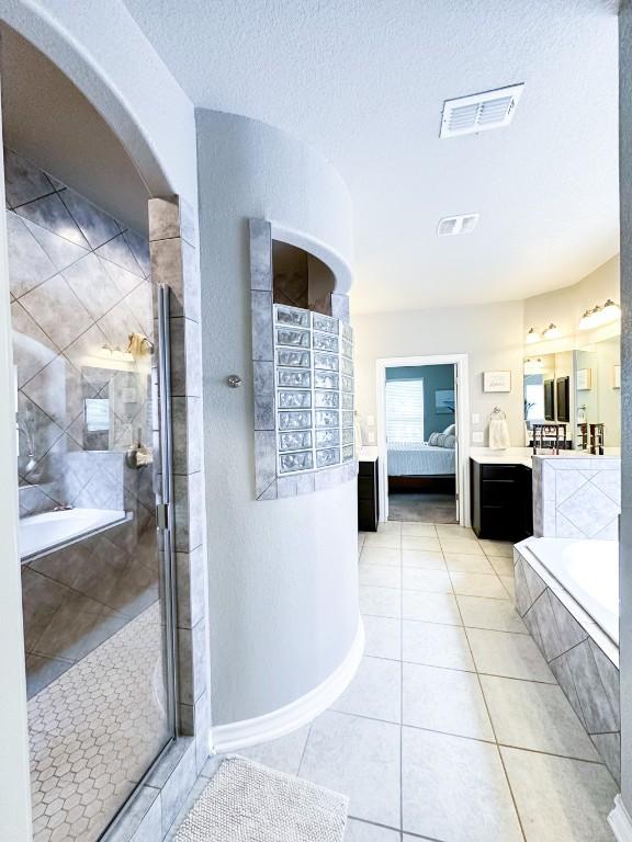 3119 Brand Iron Dr, San Marcos, TX 78666 - full bath featuring ensuite bathroom, a tile shower, vanity, a bath, and a textured ceiling
