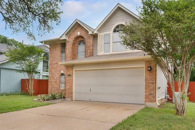 6200 La Naranja Ln, Austin, TX 78749 - traditional home with brick siding, concrete driveway, and a garage