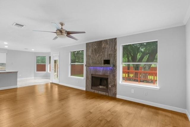 6200 La Naranja Ln, Austin, TX 78749 - unfurnished living room with a ceiling fan, baseboards, wood finished floors, a fireplace, and recessed lighting
