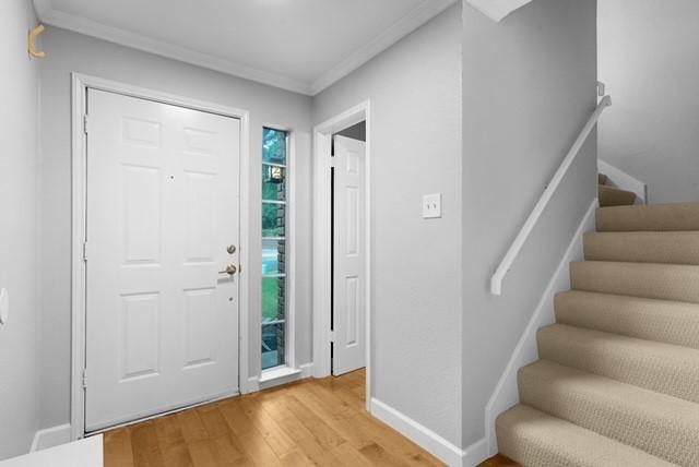 6200 La Naranja Ln, Austin, TX 78749 - entryway featuring light wood-type flooring, crown molding, stairway, and baseboards