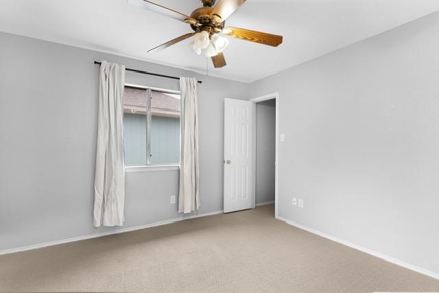 6200 La Naranja Ln, Austin, TX 78749 - unfurnished bedroom with baseboards, carpet flooring, and ceiling fan