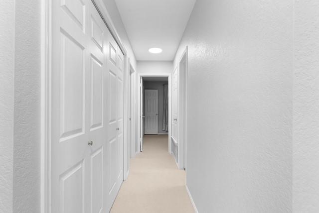 6200 La Naranja Ln, Austin, TX 78749 - corridor featuring a textured wall, baseboards, recessed lighting, and light colored carpet