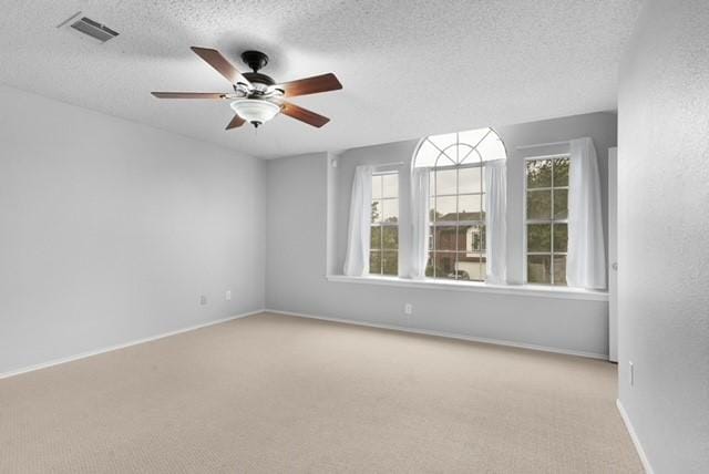 6200 La Naranja Ln, Austin, TX 78749 - empty room with light colored carpet, ceiling fan, a textured ceiling, and baseboards