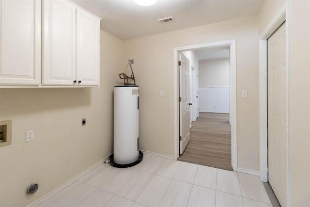 160 Turkey Run, Meadowlakes, TX 78654 - clothes washing area with electric water heater, cabinet space, hookup for an electric dryer, baseboards, and light tile patterned floors