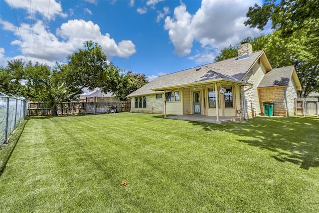 160 Turkey Run, Meadowlakes, TX 78654 - rear view of house with a patio area, a chimney, stone siding, and roof with shingles