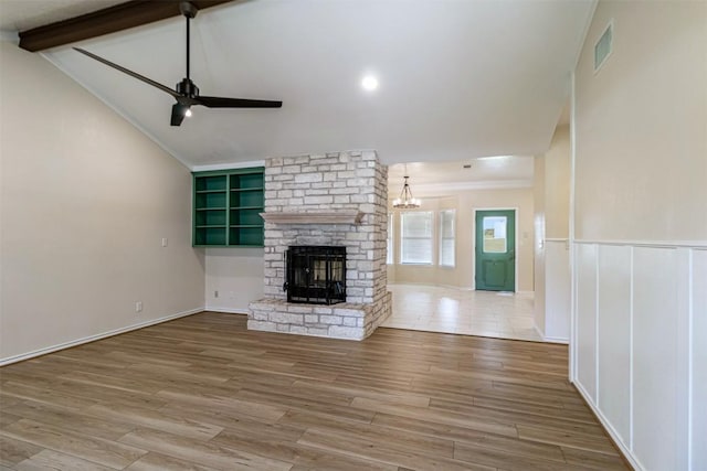 160 Turkey Run, Meadowlakes, TX 78654 - unfurnished living room featuring ceiling fan, a fireplace, wood finished floors, a chandelier, and crown molding