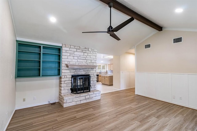 160 Turkey Run, Meadowlakes, TX 78654 - unfurnished living room featuring ceiling fan, wood finished floors, a fireplace, and wainscoting