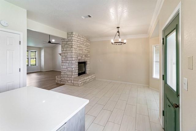 160 Turkey Run, Meadowlakes, TX 78654 - unfurnished living room featuring a chandelier, a stone fireplace, baseboards, a ceiling fan, and crown molding