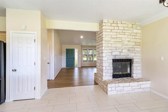 160 Turkey Run, Meadowlakes, TX 78654 - unfurnished living room featuring a multi sided fireplace, baseboards, and ornamental molding