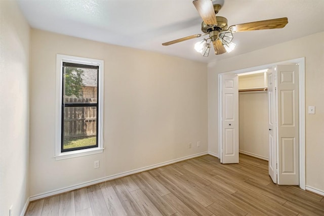 160 Turkey Run, Meadowlakes, TX 78654 - unfurnished bedroom with light wood finished floors, baseboards, ceiling fan, and a closet