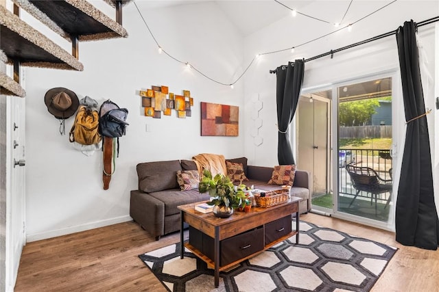 1840 Burton Dr Unit 110, Austin, TX 78741 - living room featuring light wood-type flooring, lofted ceiling, and baseboards