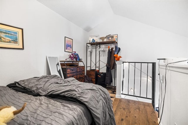 1840 Burton Dr Unit 110, Austin, TX 78741 - bedroom featuring vaulted ceiling and wood finished floors