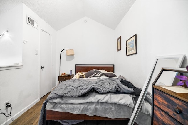 1840 Burton Dr Unit 110, Austin, TX 78741 - bedroom featuring lofted ceiling, wood finished floors, a textured ceiling, and baseboards
