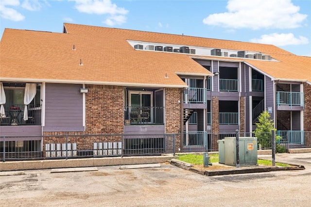 1840 Burton Dr Unit 110, Austin, TX 78741 - view of property with uncovered parking and fence
