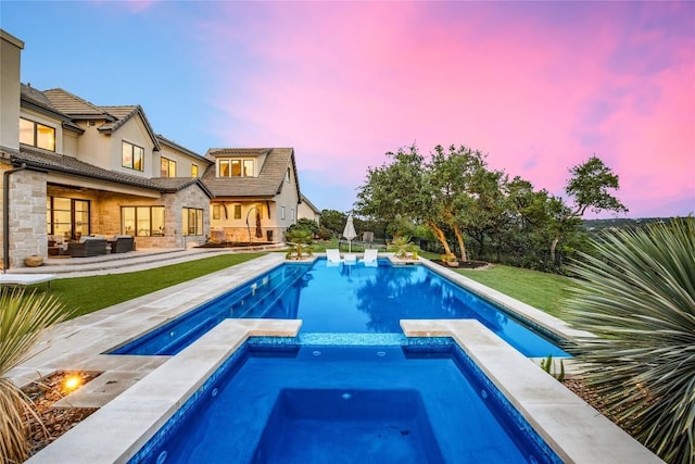 11705 Shoreview Overlook, Austin, TX 78732 - pool at dusk featuring a pool with connected hot tub, outdoor lounge area, a lawn, and a patio area