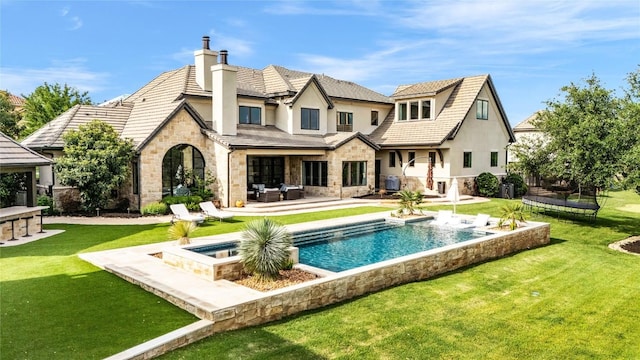 11705 Shoreview Overlook, Austin, TX 78732 - back of house featuring stone siding, stucco siding, a chimney, an outdoor living space, and a yard