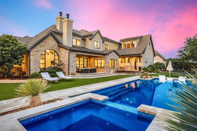 11705 Shoreview Overlook, Austin, TX 78732 - rear view of house with stone siding, a chimney, an outdoor hangout area, a pool with connected hot tub, and stucco siding