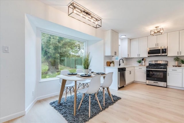 9606 Dallum Dr, Austin, TX 78753 - kitchen featuring appliances with stainless steel finishes, tasteful backsplash, a sink, white cabinets, and light countertops