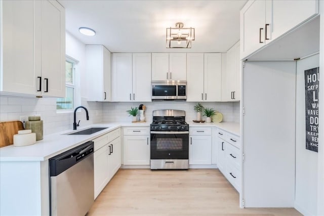 9606 Dallum Dr, Austin, TX 78753 - kitchen featuring stainless steel appliances, a sink, tasteful backsplash, and white cabinets