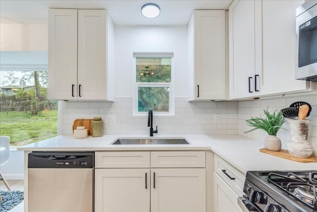 9606 Dallum Dr, Austin, TX 78753 - kitchen featuring stainless steel appliances, a sink, white cabinetry, and light countertops