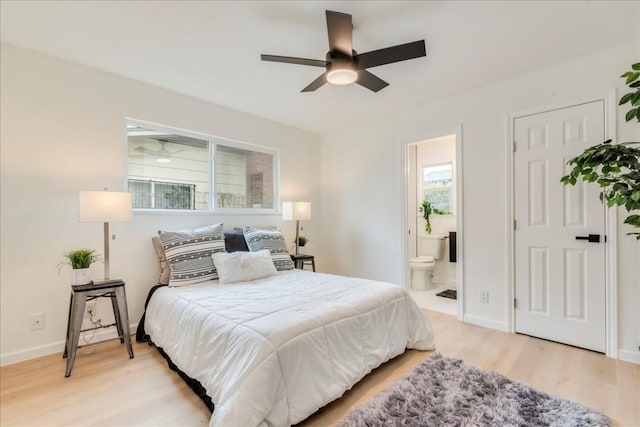 9606 Dallum Dr, Austin, TX 78753 - bedroom featuring light wood-style flooring, connected bathroom, baseboards, and a ceiling fan