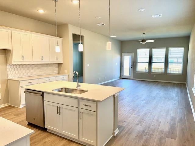 328 Milkwood Ter, Dripping Springs, TX 78620 - kitchen with a sink, dishwasher, ceiling fan, light wood-type flooring, and a center island with sink