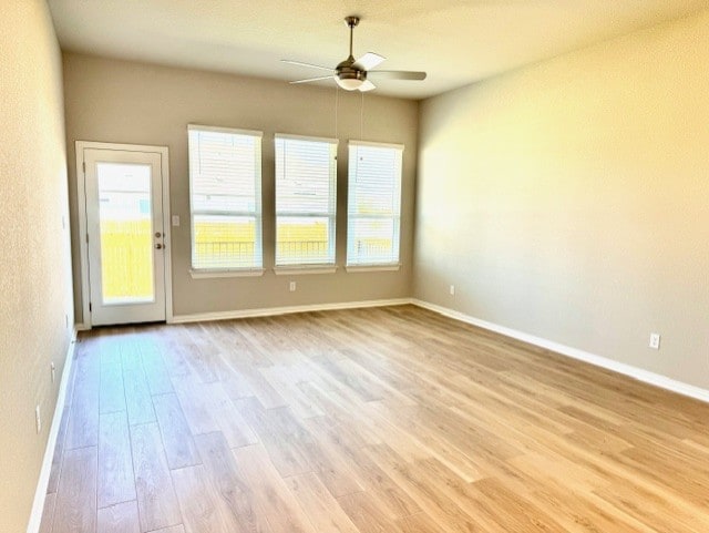 328 Milkwood Ter, Dripping Springs, TX 78620 - spare room featuring ceiling fan, light wood finished floors, and baseboards