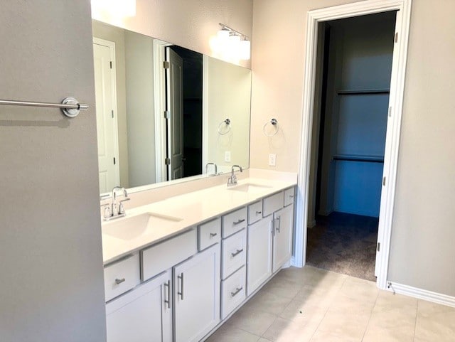 328 Milkwood Ter, Dripping Springs, TX 78620 - full bathroom featuring double vanity, tile patterned flooring, and baseboards
