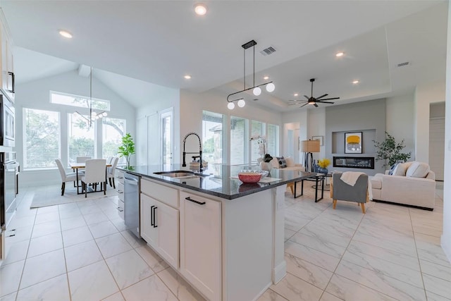 kitchen featuring a sink, a chandelier, light marble finish flooring, pendant lighting, and lofted ceiling