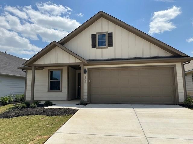 200 Hidalgo Ln, Elgin, TX 78621 - view of front of house with board and batten siding and driveway
