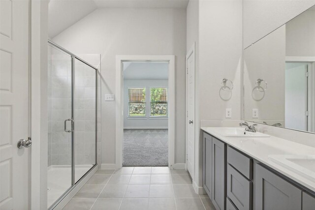 200 Hidalgo Ln, Elgin, TX 78621 - full bathroom with a stall shower, tile patterned flooring, double vanity, baseboards, and lofted ceiling