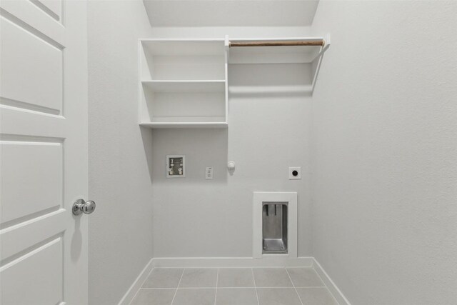 200 Hidalgo Ln, Elgin, TX 78621 - laundry area with hookup for an electric dryer, light tile patterned floors, hookup for a gas dryer, hookup for a washing machine, and baseboards