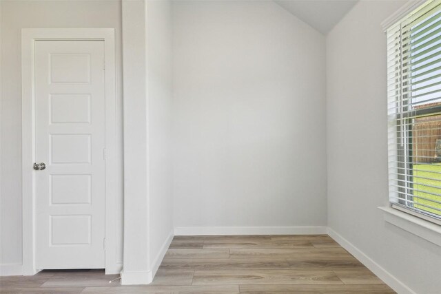 200 Hidalgo Ln, Elgin, TX 78621 - unfurnished room featuring plenty of natural light, light wood-type flooring, lofted ceiling, and baseboards