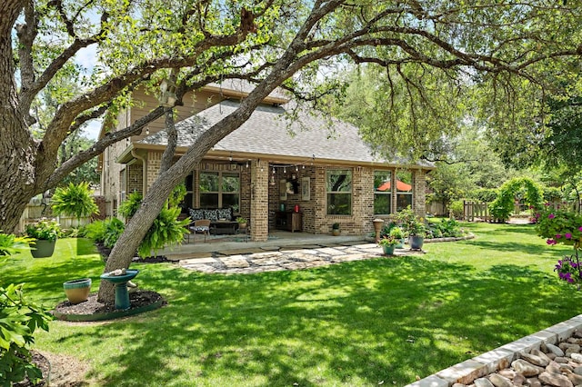1720 Foxboro Ln, Cedar Park, TX 78613 - rear view of house with brick siding, a patio, and roof with shingles