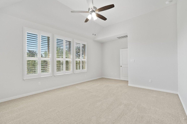 unfurnished room with light colored carpet, ceiling fan, lofted ceiling, and baseboards