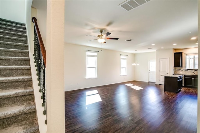 253 Beechnut Dr, Buda, TX 78610 - unfurnished living room featuring dark wood-style flooring, a ceiling fan, stairway, baseboards, and recessed lighting