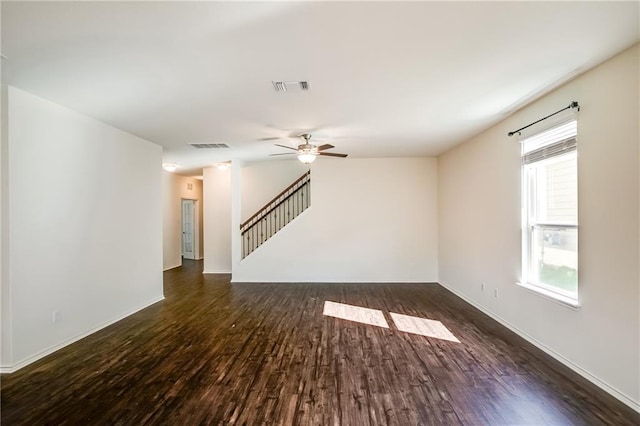 253 Beechnut Dr, Buda, TX 78610 - unfurnished living room featuring wood finished floors, ceiling fan, stairway, and baseboards